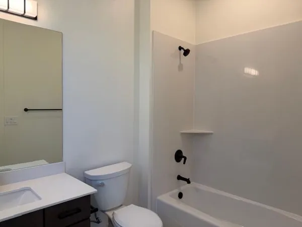 a view of an empty walk in closet with wooden floor