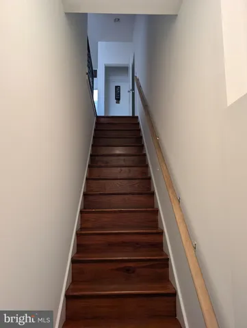 a kitchen with stainless steel appliances granite countertop a refrigerator a stove top oven a sink and dishwasher with wooden floor