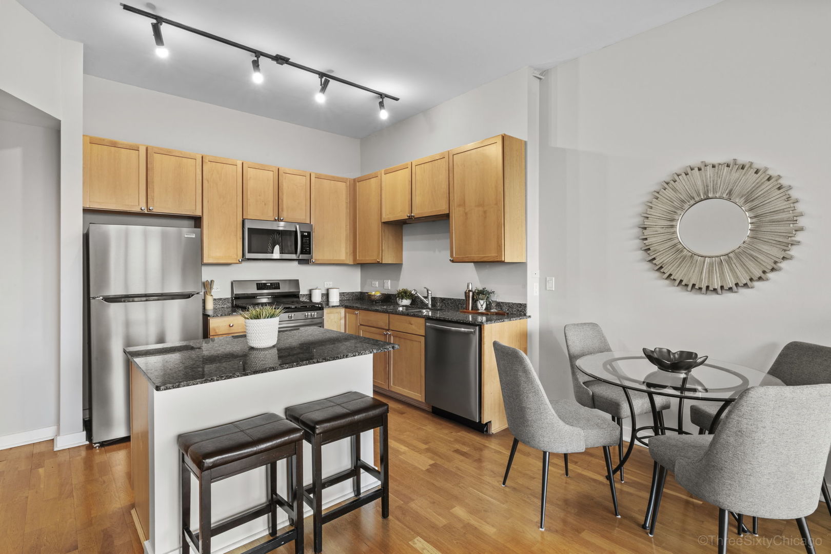 901 West Madison Street, Unit 603 Chicago, IL 60607 - Photo 11 of 25 a kitchen with a dining table chairs and refrigerator