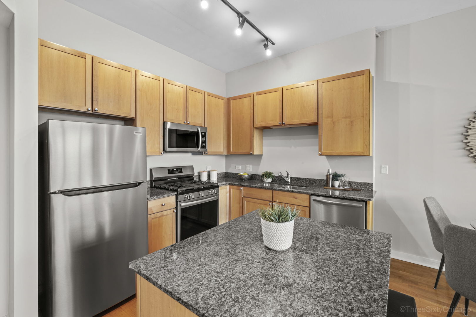 901 West Madison Street, Unit 603 Chicago, IL 60607 - Photo 12 of 25 a kitchen with stainless steel appliances granite countertop a refrigerator stove microwave and sink