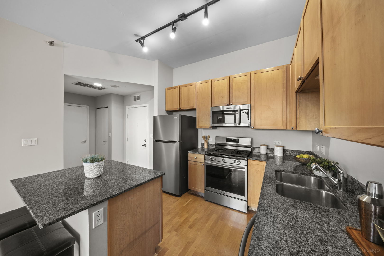 901 West Madison Street, Unit 603 Chicago, IL 60607 - Photo 13 of 25 a kitchen with stainless steel appliances granite countertop a sink stove and refrigerator
