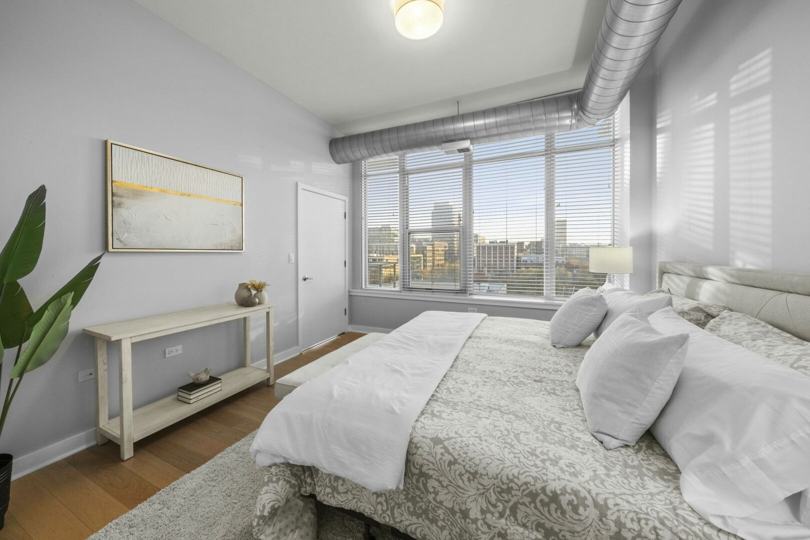 901 West Madison Street, Unit 603 Chicago, IL 60607 - Photo 15 of 25 a bedroom with a bed and a large window