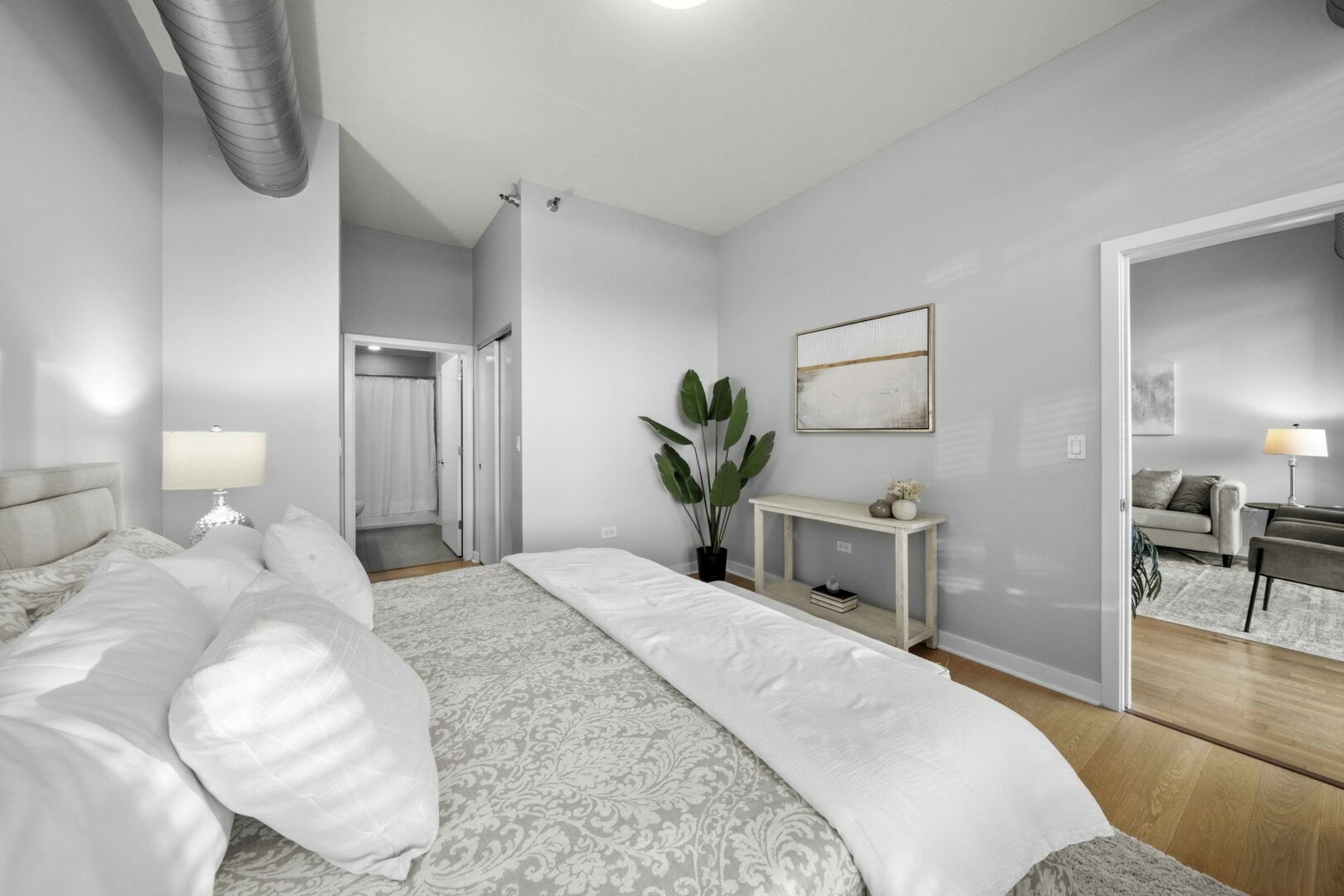 901 West Madison Street, Unit 603 Chicago, IL 60607 - Photo 16 of 25 a bedroom with a bed and a potted plant