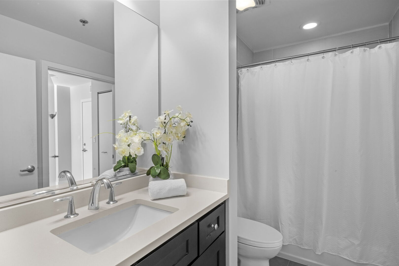 901 West Madison Street, Unit 603 Chicago, IL 60607 - Photo 17 of 25 a bathroom with a sink a toilet and shower curtain