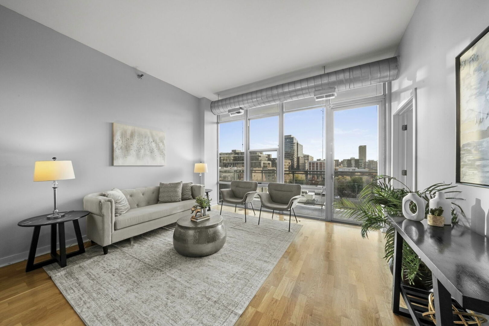 901 West Madison Street, Unit 603 Chicago, IL 60607 - Photo 3 of 25 a living room with furniture and a wooden floor