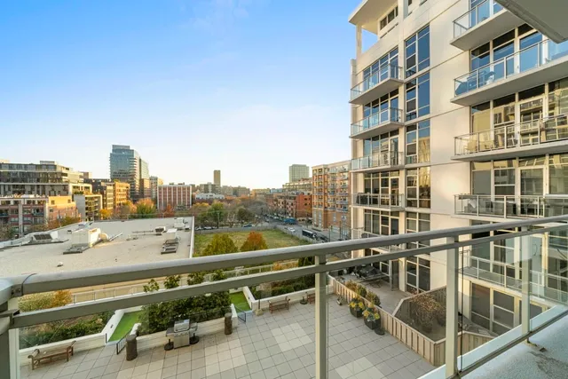 a view of a city from a balcony with a patio