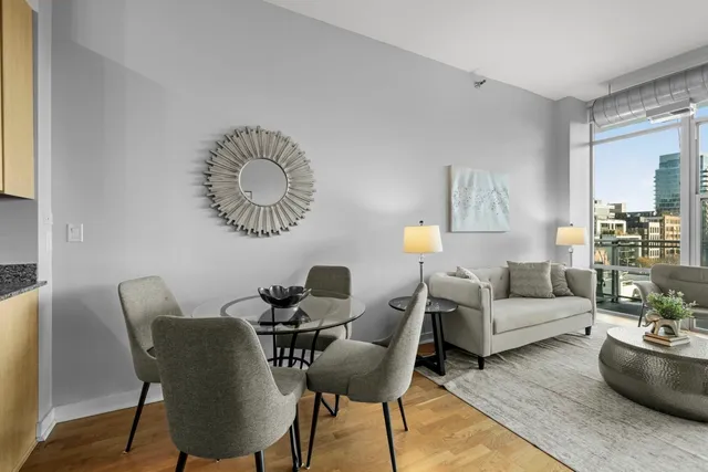 a living room with furniture and a wooden floor