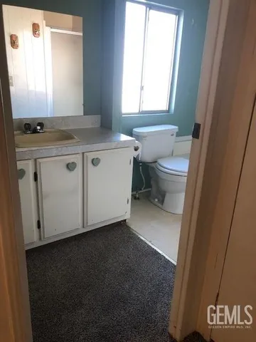 a view of kitchen with granite countertop white cabinets and black appliances