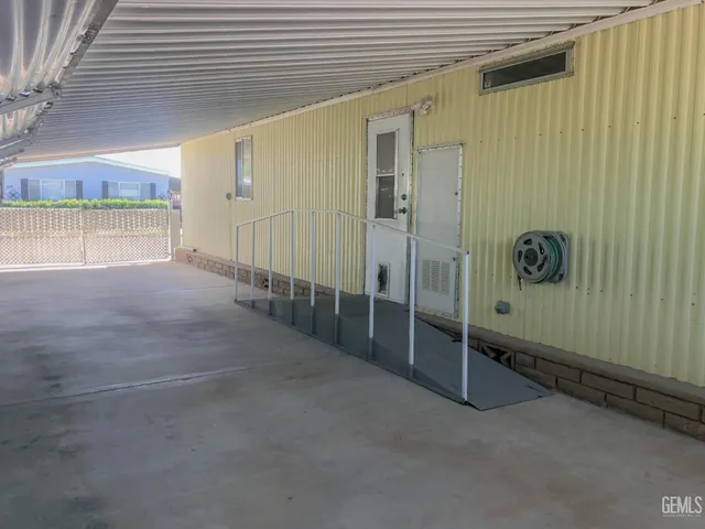 a view of empty room with window and wooden floor