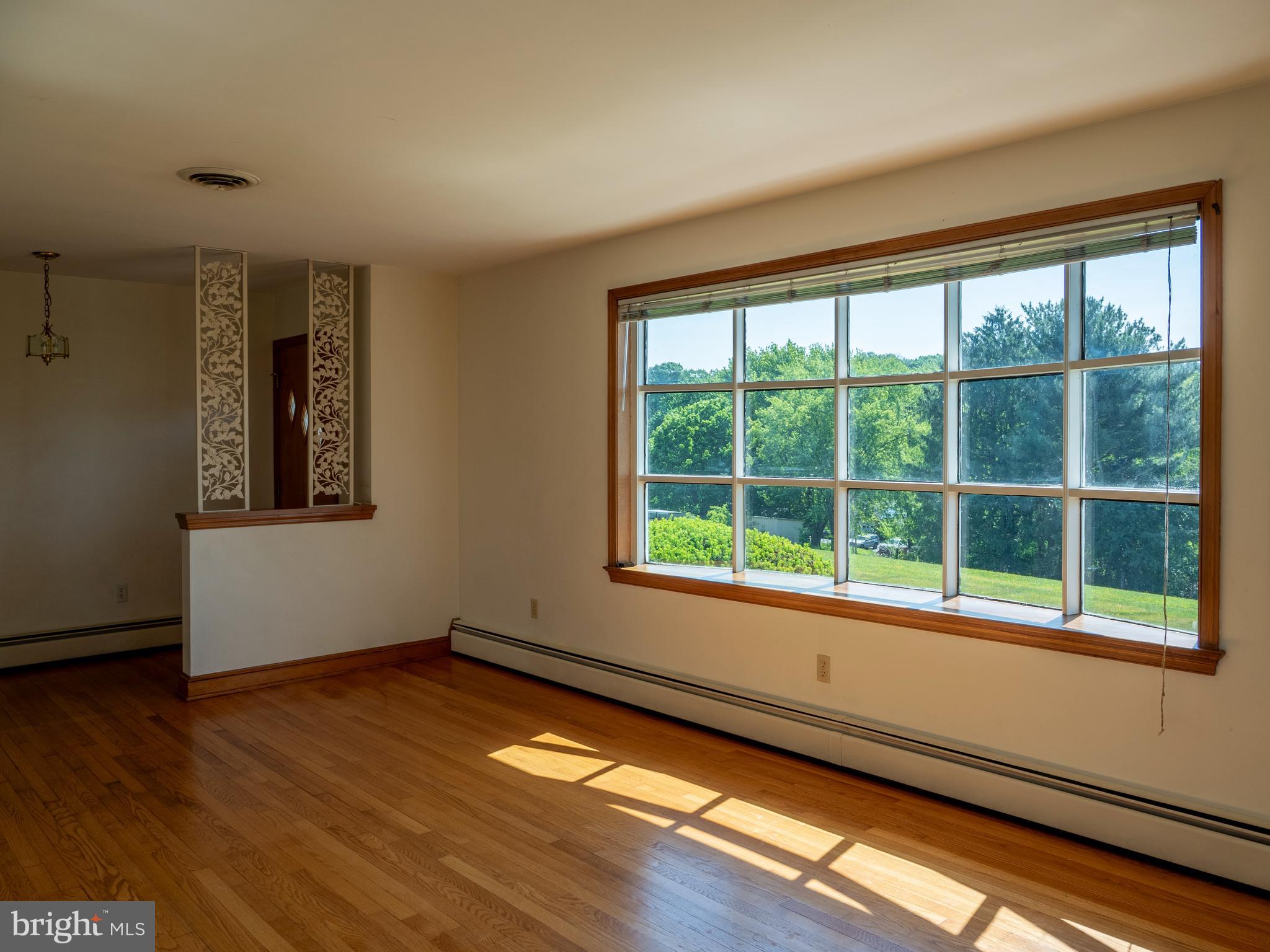 26906 Clarksburg Road Damascus, MD 20872 - Photo 5 of 17 a view of an empty room with wooden floor and a window
