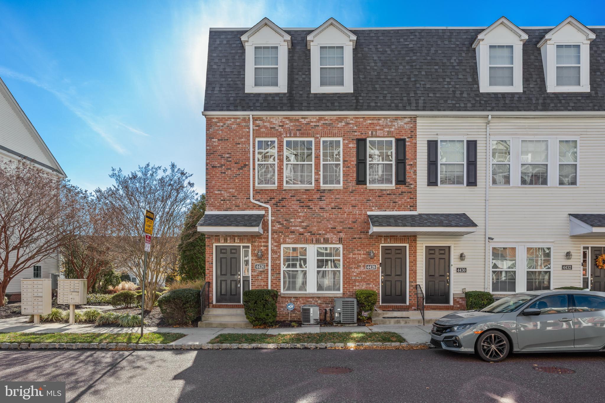 Charming townhome with classic brick facade.