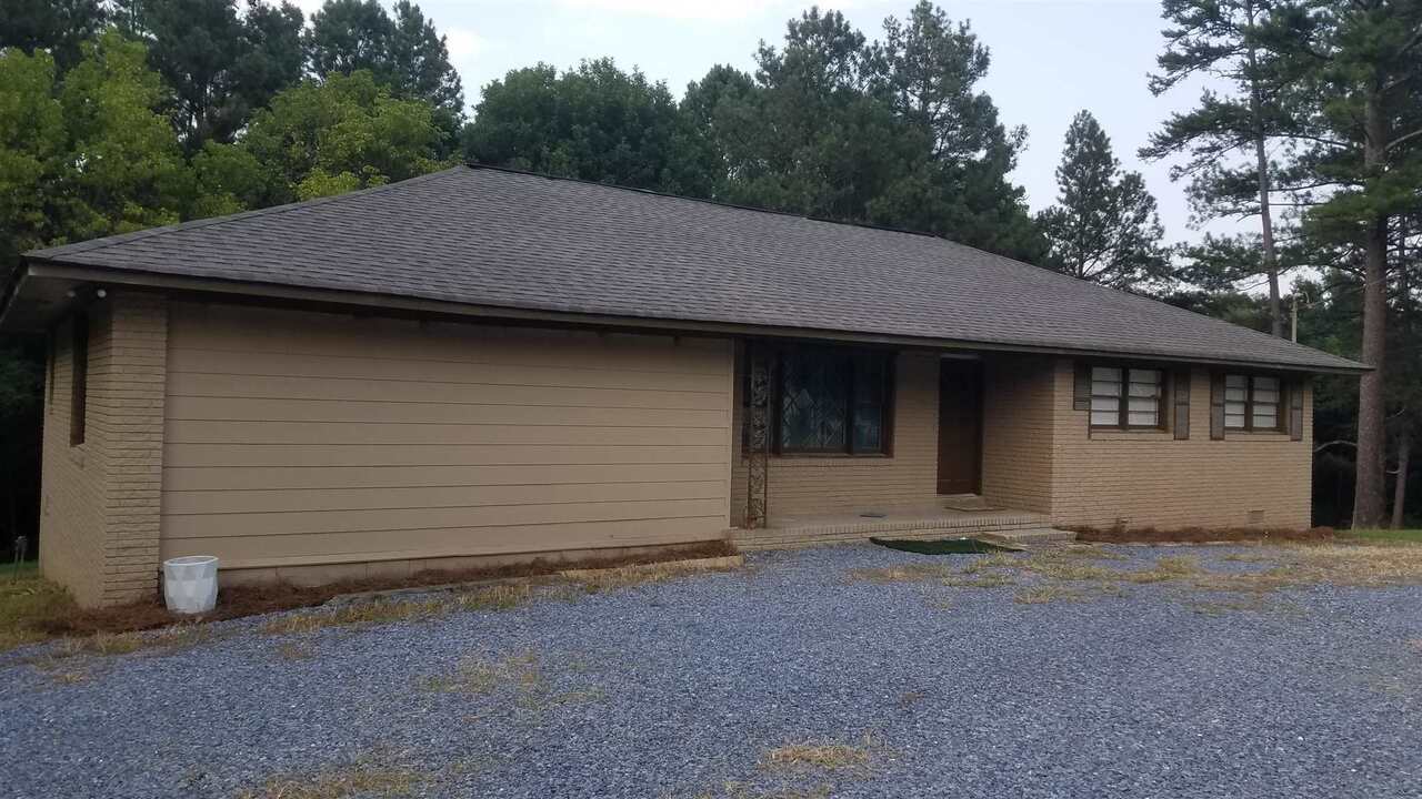 1025 Collard Valley Road Cedartown, GA 30125 - Photo 1 of 1 a house with trees in the background