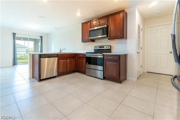 a kitchen with stainless steel appliances a stove a sink and a microwave
