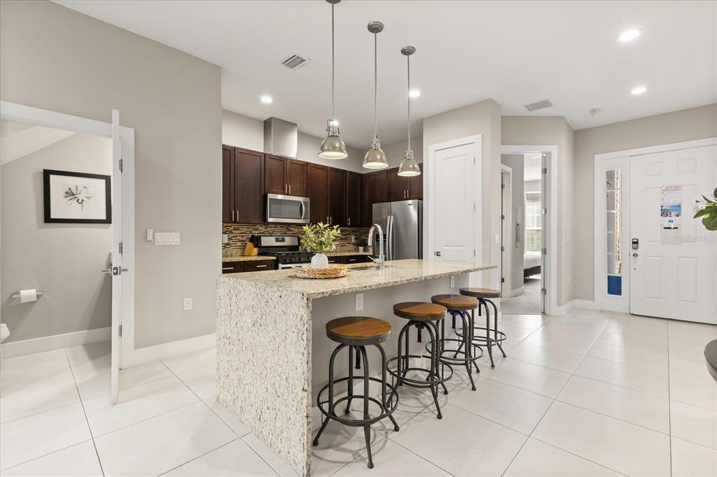 2637 Sunrise Shores Drive Kissimmee, FL 34747 - Photo 11 of 39 a large kitchen with a table and chairs