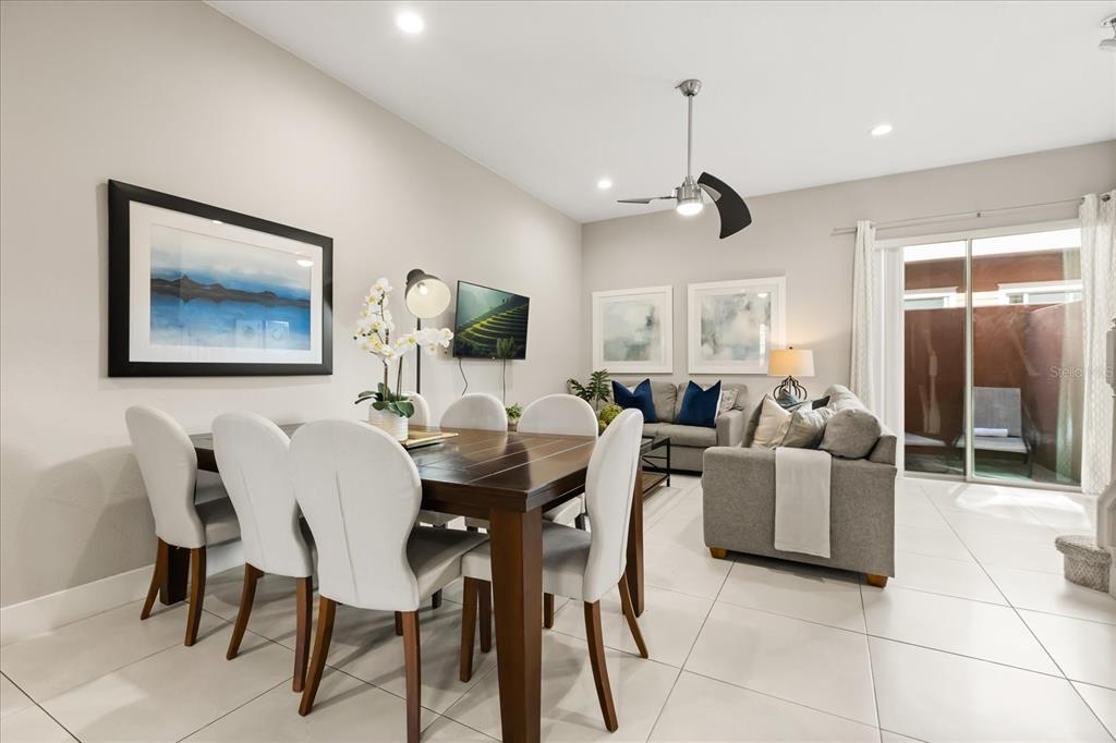 2637 Sunrise Shores Drive Kissimmee, FL 34747 - Photo 13 of 39 a living room with furniture a dining table and a painting on the wall