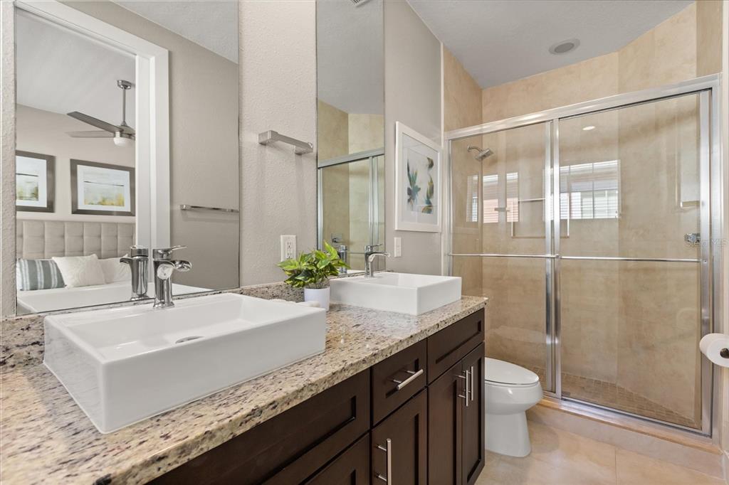 2637 Sunrise Shores Drive Kissimmee, FL 34747 - Photo 17 of 39 a bathroom with a granite countertop sink mirror and toilet