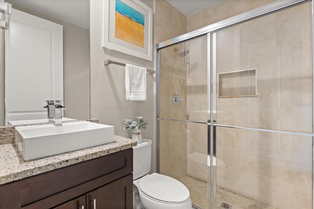 2637 Sunrise Shores Drive Kissimmee, FL 34747 - Photo 20 of 39 a bathroom with a sink a toilet and shower