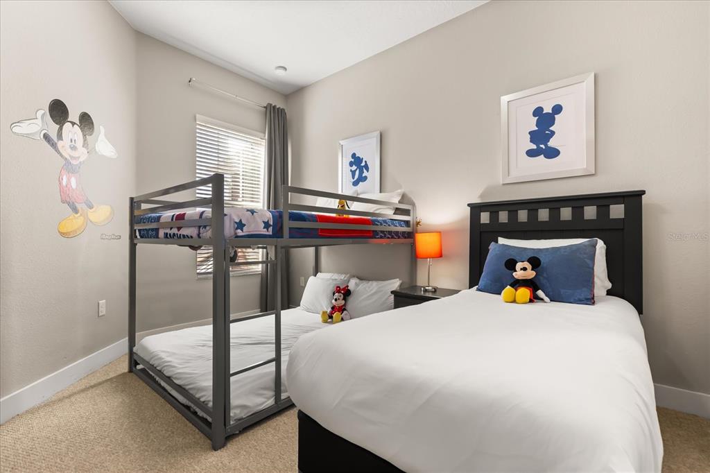 2637 Sunrise Shores Drive Kissimmee, FL 34747 - Photo 24 of 39 a bedroom with a bed and wooden floor