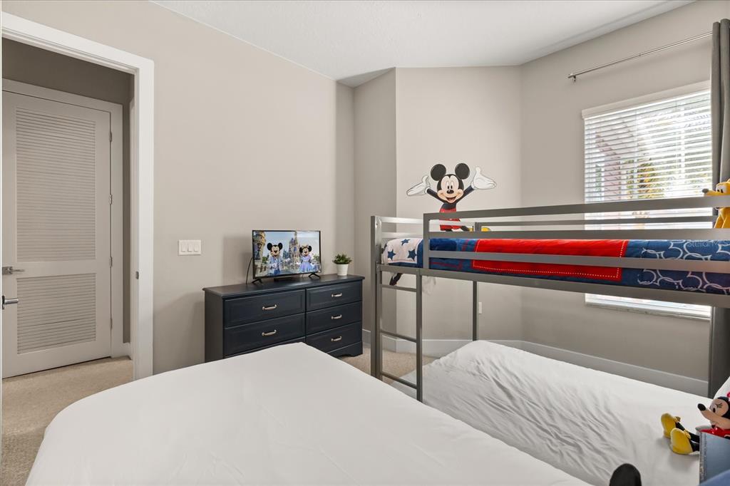 2637 Sunrise Shores Drive Kissimmee, FL 34747 - Photo 25 of 39 a bedroom with a bed and a dresser