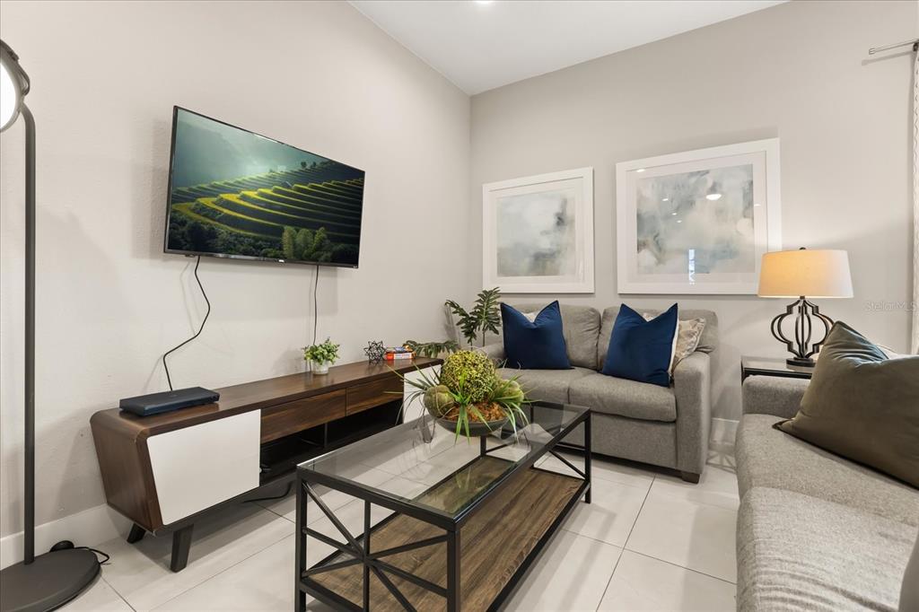 2637 Sunrise Shores Drive Kissimmee, FL 34747 - Photo 31 of 39 a living room with furniture and a flat screen tv
