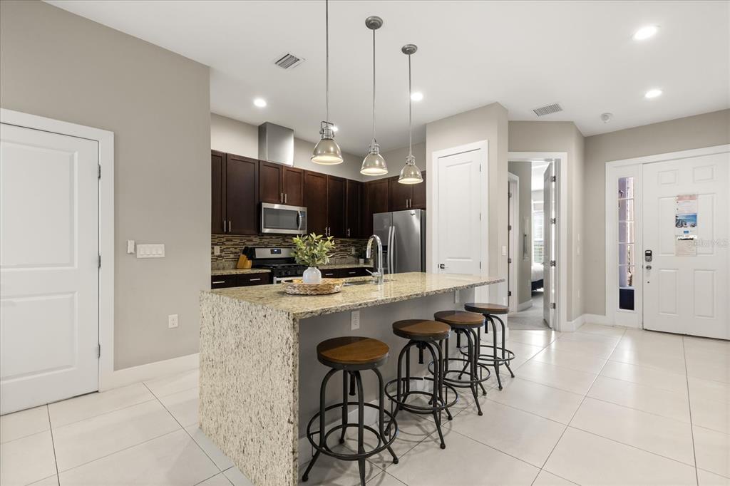 2637 Sunrise Shores Drive Kissimmee, FL 34747 - Photo 10 of 39 a large kitchen with a table and chairs