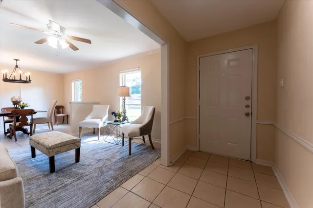 a living room with furniture and a chandelier