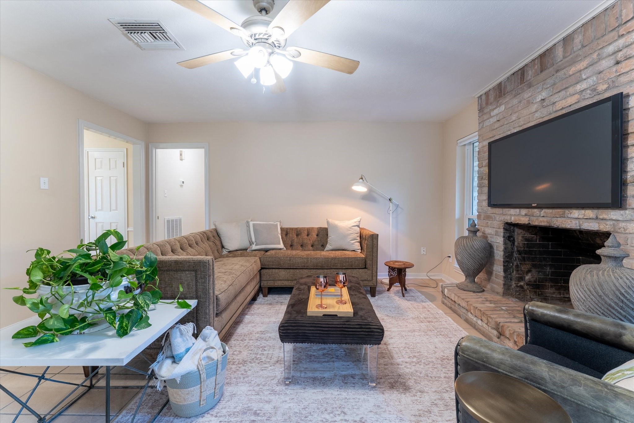 25019 Barmby Drive Spring, TX 77389 - Photo 17 of 43 a living room with furniture a fireplace and a flat screen tv