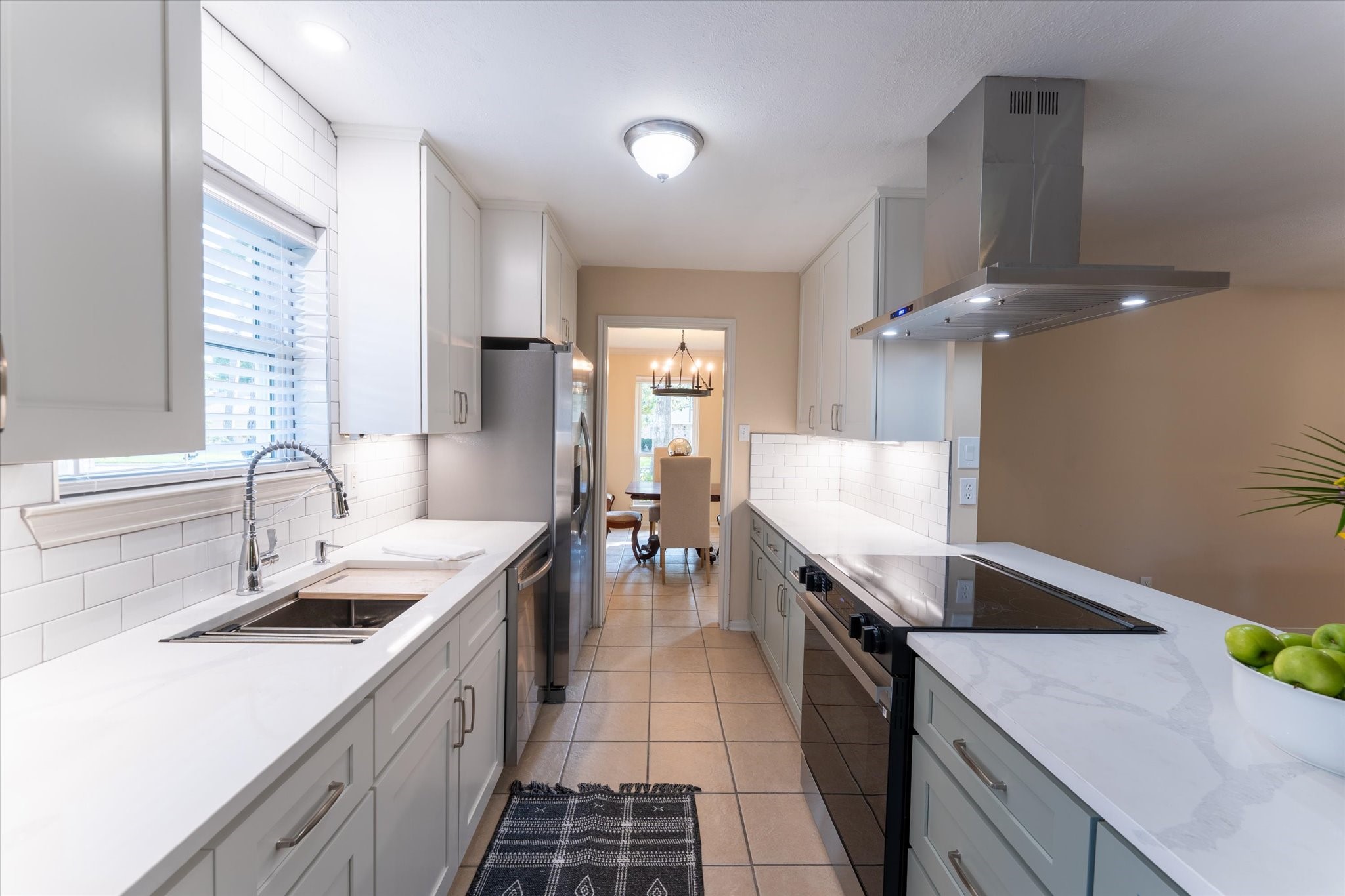 25019 Barmby Drive Spring, TX 77389 - Photo 24 of 43 a large kitchen with granite countertop a sink and dishwasher a stove top oven with wooden floor