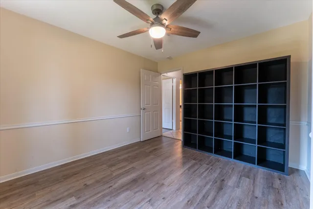 an empty room with windows and cabinet