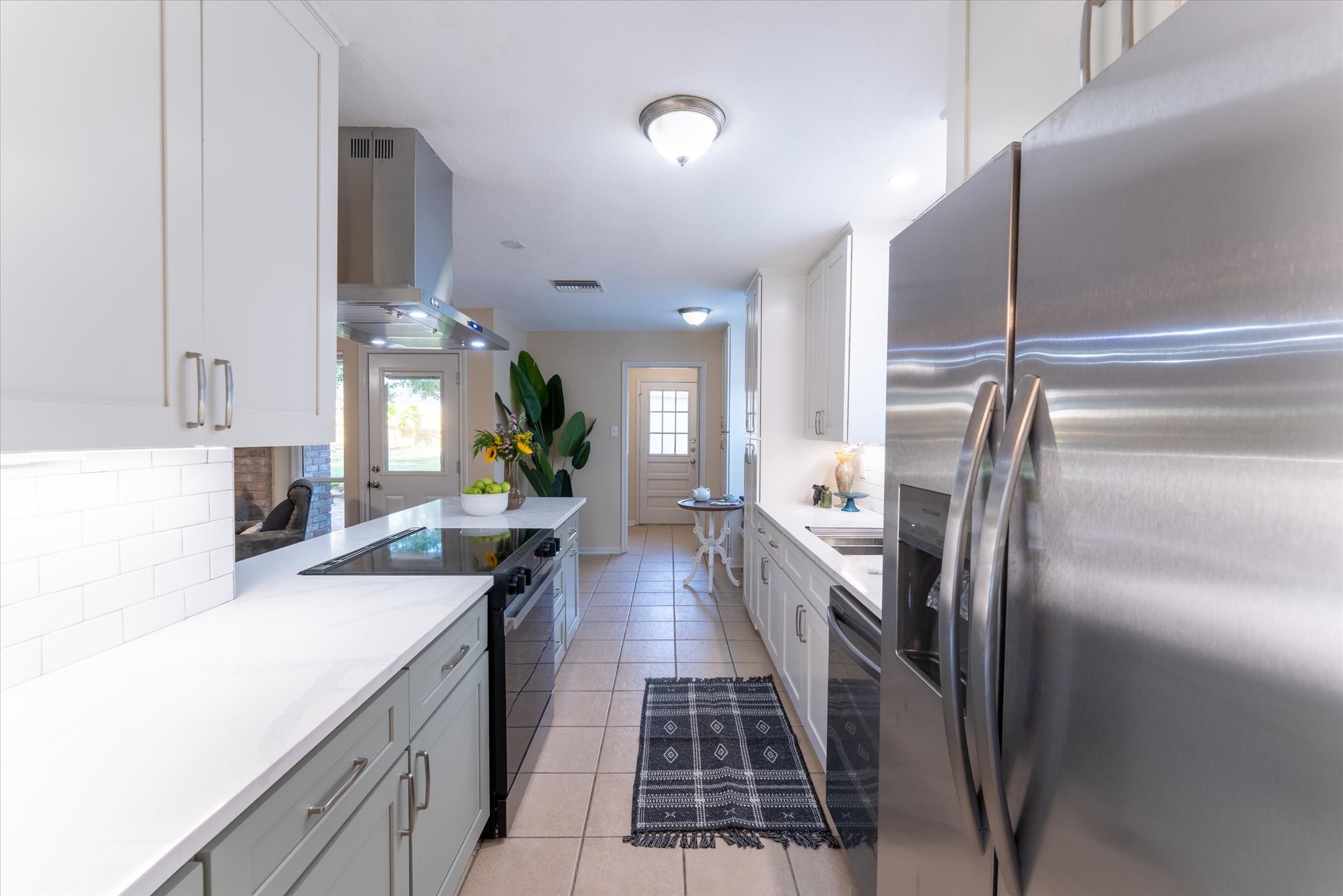 25019 Barmby Drive Spring, TX 77389 - Photo 27 of 43 a kitchen with kitchen island a counter top space a sink stainless steel appliances and cabinets