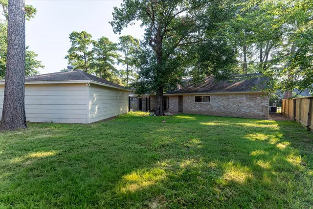 a front view of a house with a garden and trees