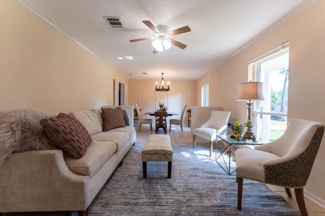 a living room with furniture and white walls