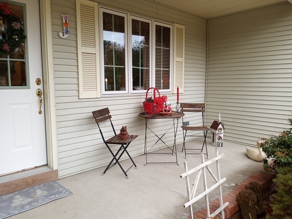 1753 White Pond Road Athol, MA 01331 - Photo 4 of 33 a balcony with table and chairs and potted plants