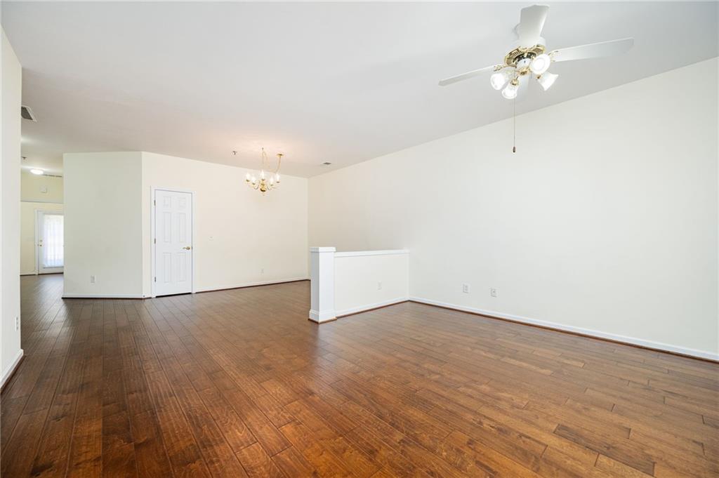 248 Riverstone Place Canton, GA 30114 - Photo 11 of 29 an empty room with wooden floor and ceiling fan