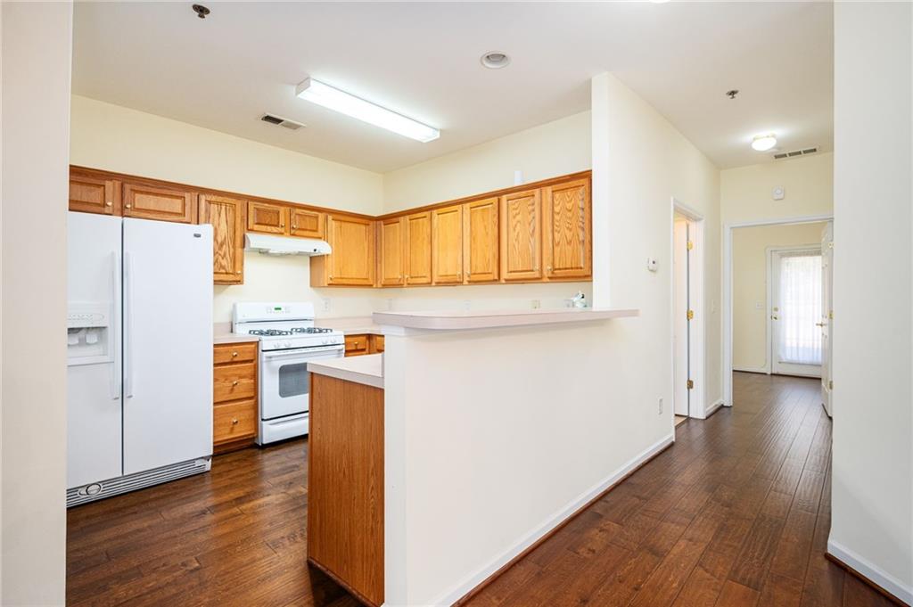 248 Riverstone Place Canton, GA 30114 - Photo 17 of 29 a kitchen with stainless steel appliances a refrigerator and a stove top oven