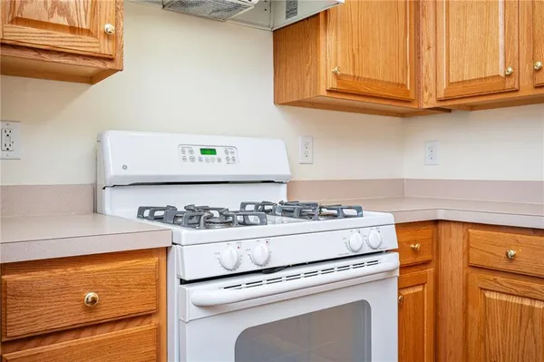 a stove top oven sitting inside of a kitchen