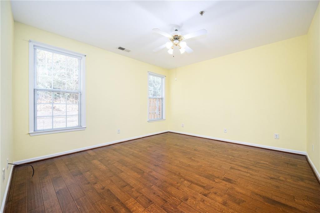 248 Riverstone Place Canton, GA 30114 - Photo 21 of 29 a view of an empty room with wooden floor and a window