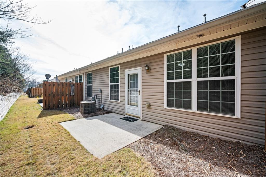 248 Riverstone Place Canton, GA 30114 - Photo 25 of 29 a view of a backyard with a chair and wooden fence