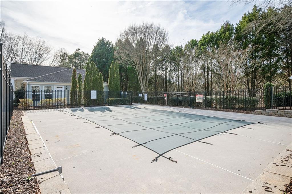 248 Riverstone Place Canton, GA 30114 - Photo 28 of 29 a view of a backyard with a white fence