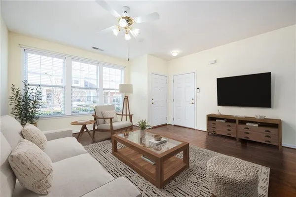 a living room with furniture and a flat screen tv