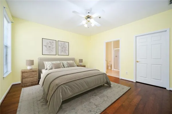 a spacious bedroom with a bed and a chandelier