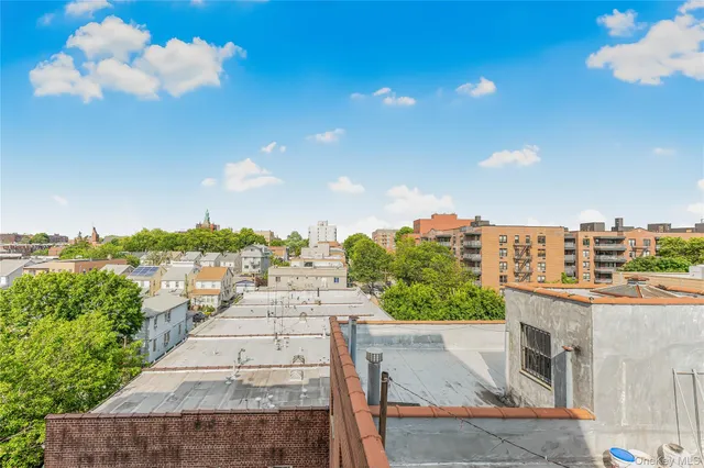 an empty room with a window and wooden floor