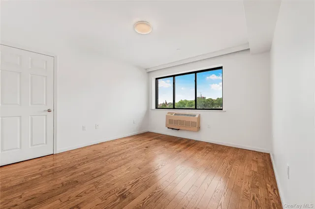 a bathroom with a granite countertop sink a toilet a mirror and shower