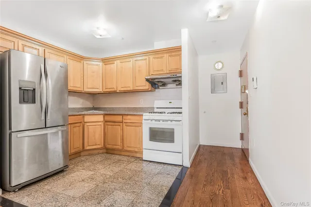a kitchen with a refrigerator stove and white cabinets