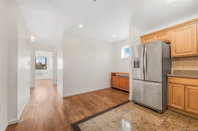 a kitchen with a refrigerator and a stove top oven