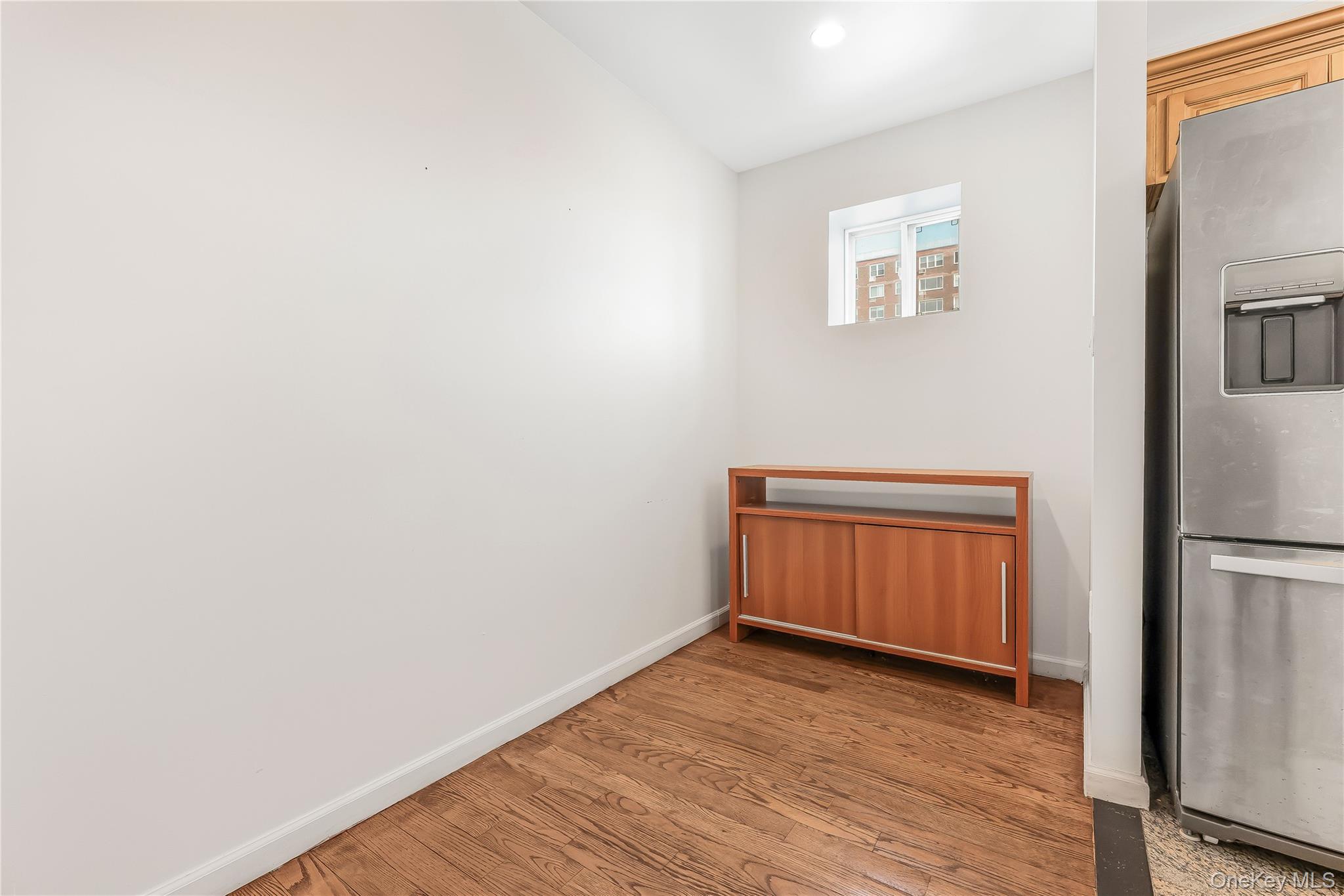 85-23 Broadway, Unit 7C Queens, NY 11373 - Photo 9 of 33 Kitchen featuring stainless steel fridge, light wood-type flooring, and recessed lighting