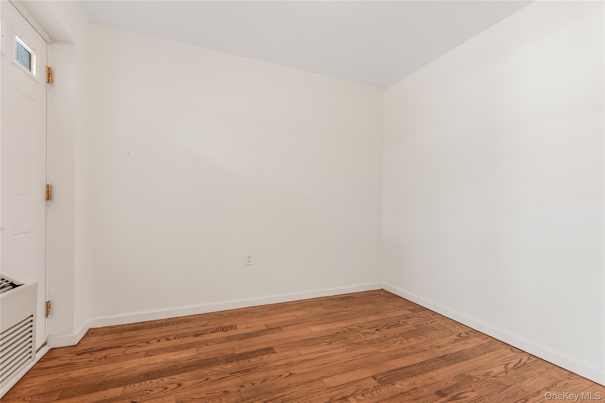 85-23 Broadway, Unit 7C Queens, NY 11373 - Photo 10 of 33 Empty room featuring light wood-type flooring and baseboards