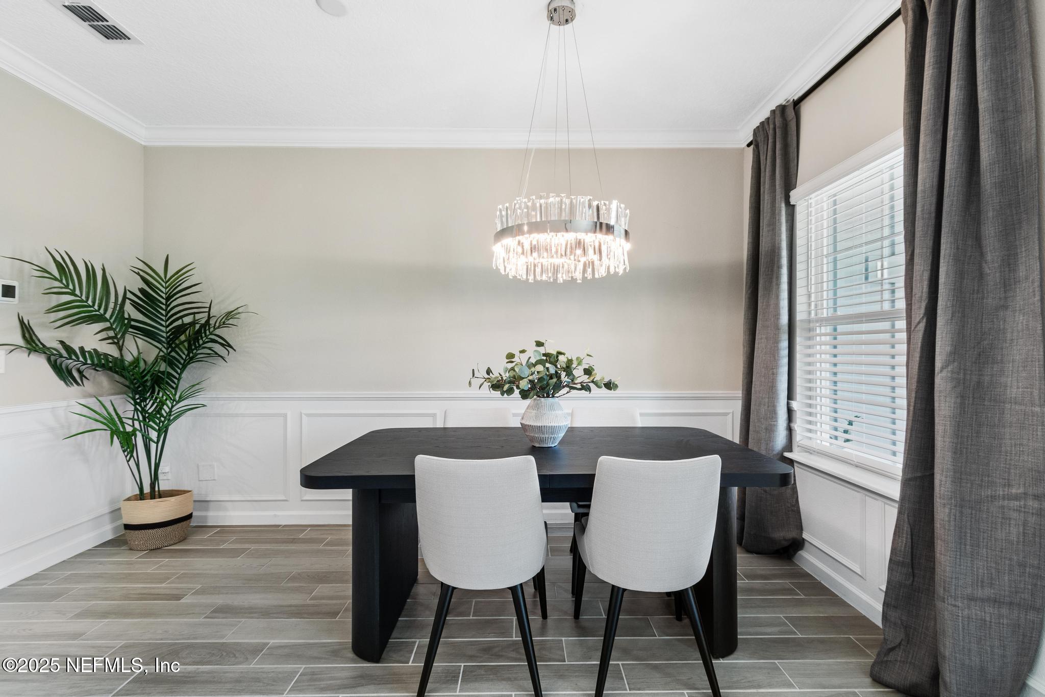 155 Appleton Court St. Augustine, FL 32092 - Photo 13 of 56 a view of a dining room with furniture a potted plant and wooden floor