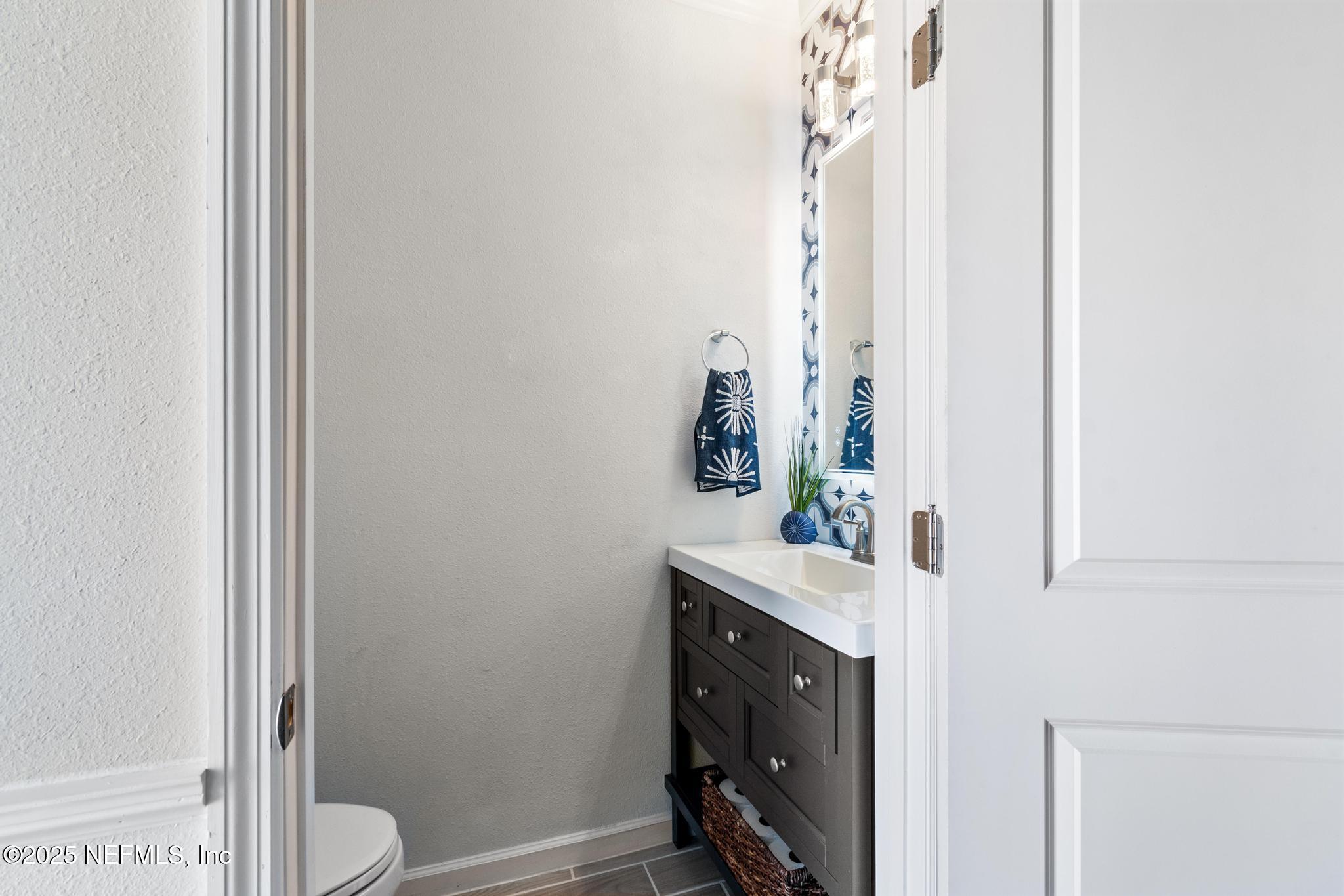 155 Appleton Court St. Augustine, FL 32092 - Photo 18 of 56 a bathroom with a sink a toilet and shower curtain
