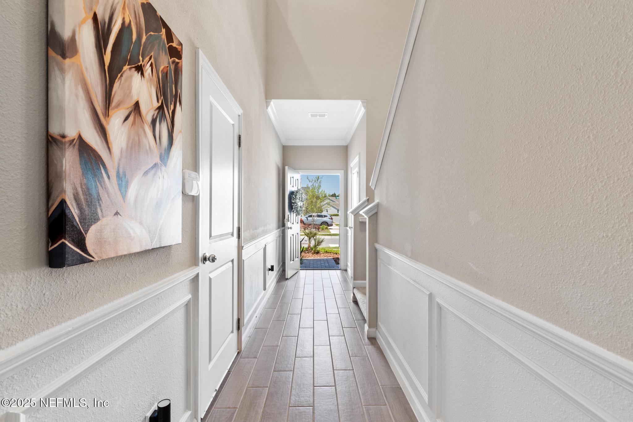 155 Appleton Court St. Augustine, FL 32092 - Photo 2 of 56 a view of a hallway with wooden floor and a bathroom